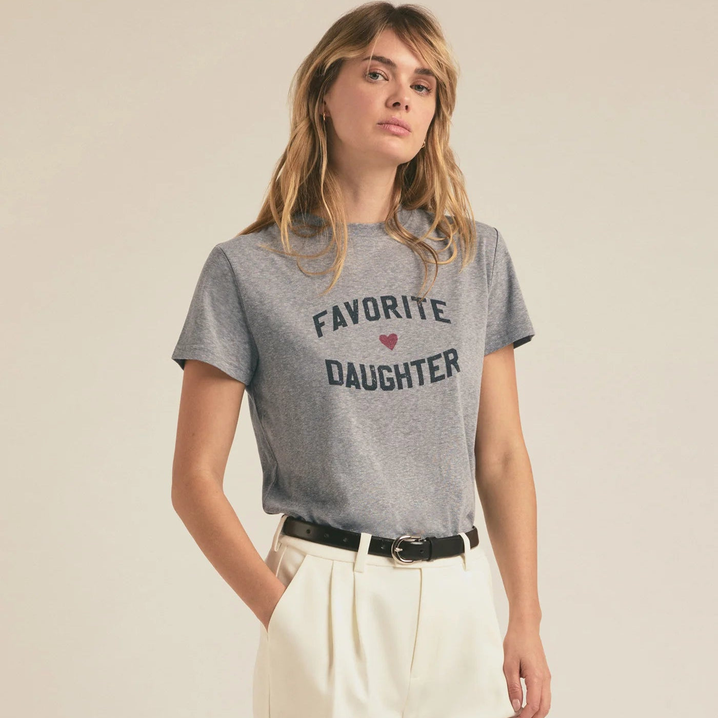 Woman wearing a heather grey t-shirt with 'Favorite Daughter' text on the front