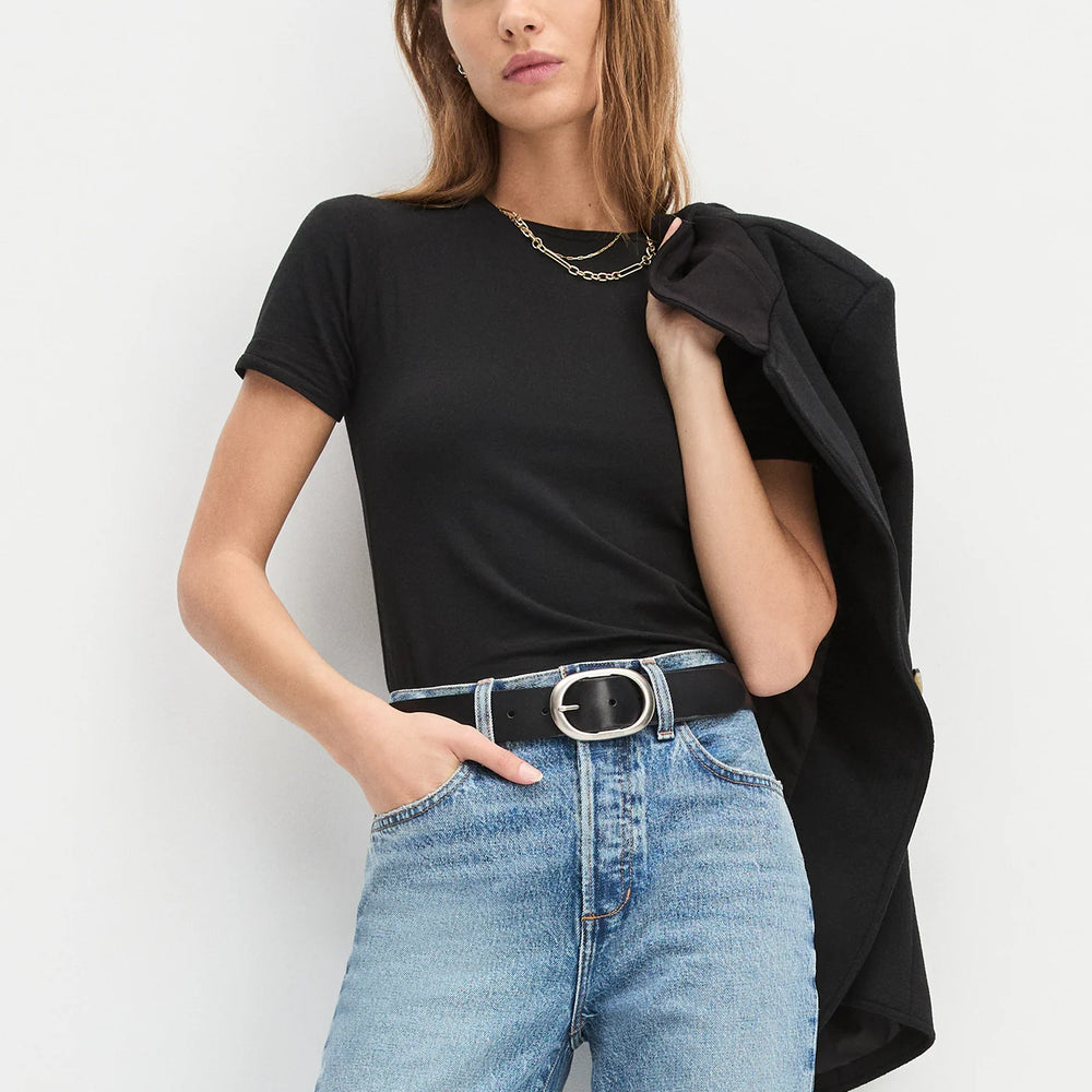 
                      
                        A woman wearing a black tee and jeans with The Jean Belt from Favorite Daughter
                      
                    