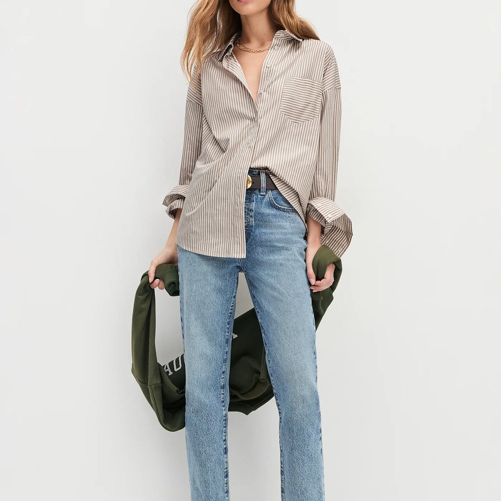 A woman wearing the Favorite Daughter The Beau Shirt in Mocha Stripe