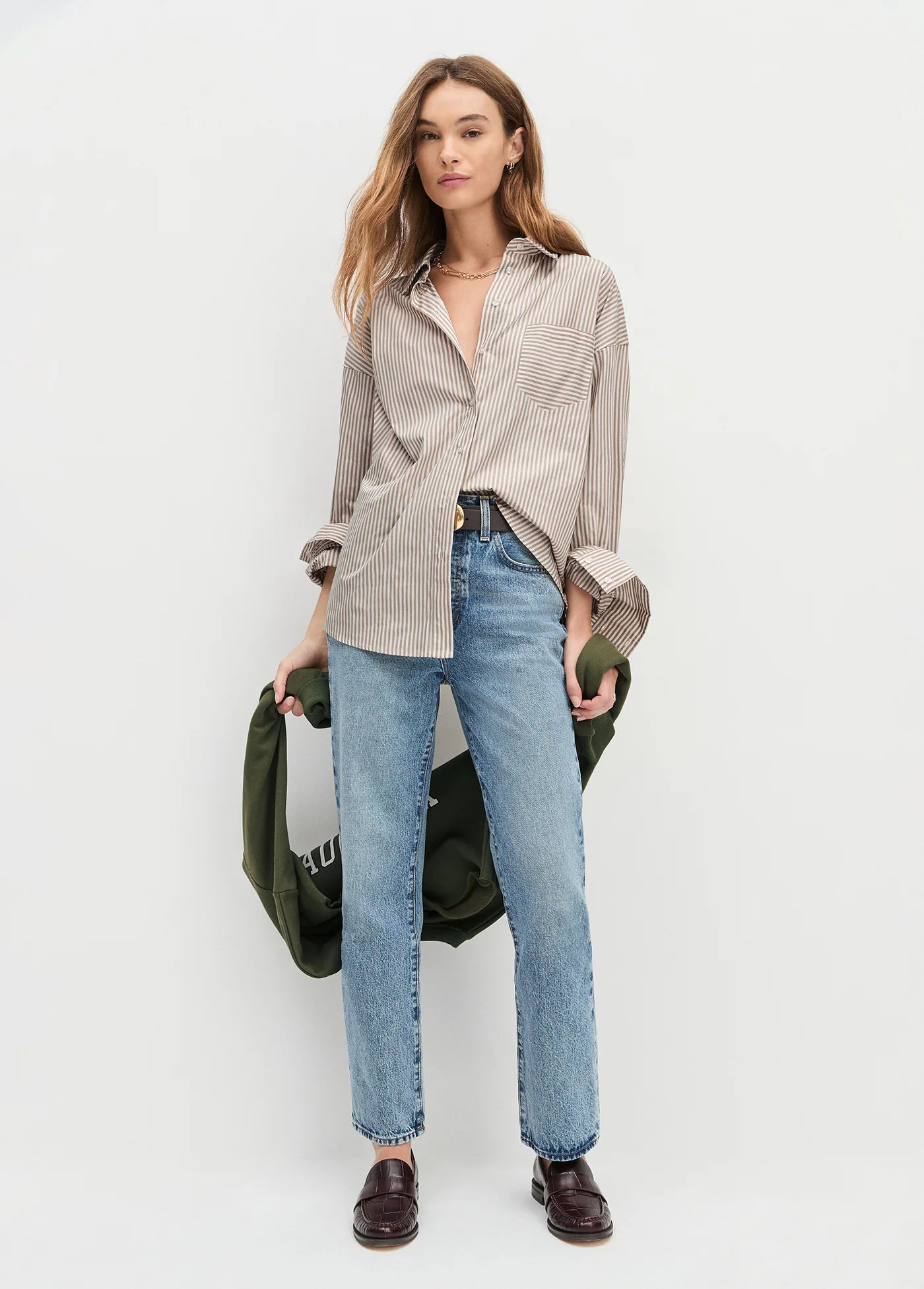 A woman wearing the Favorite Daughter The Beau Shirt in Mocha Stripe