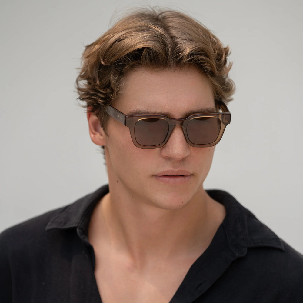 
                      
                        A man wearing the FREYRS Atlas Mens Rectangular Sunglasses in Brown
                      
                    