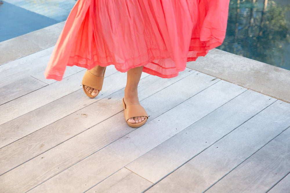 
                      
                        A woman walking in the Gallito Leather Slide Sandasl by beek
                      
                    