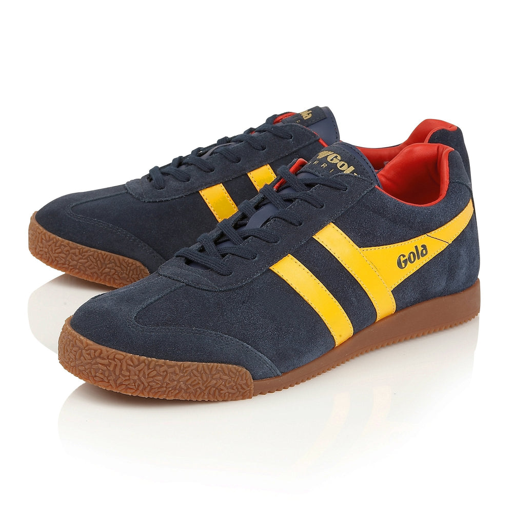 Navy blue sneakers with yellow stripes and red lining 