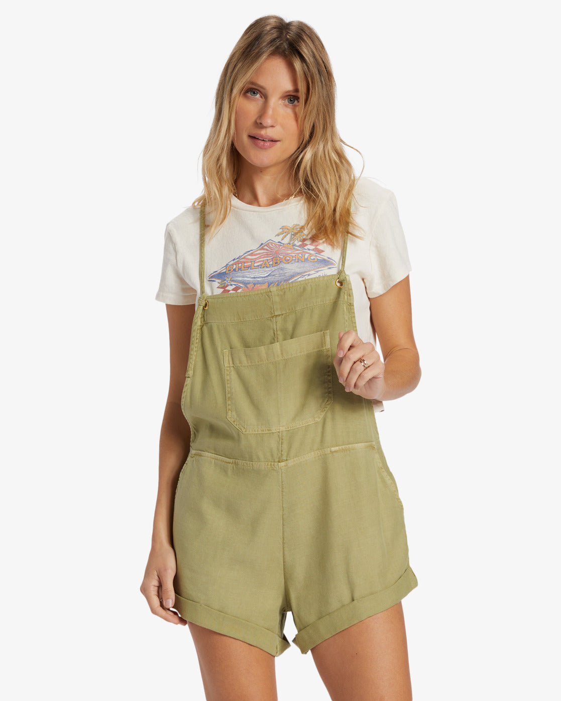 Front view of model wearing an avocado green color shorts romper by Billabong