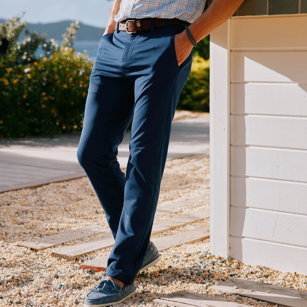 
                      
                        Side view of a man wearing the navy Jack Performance Pants by Southern Tide
                      
                    