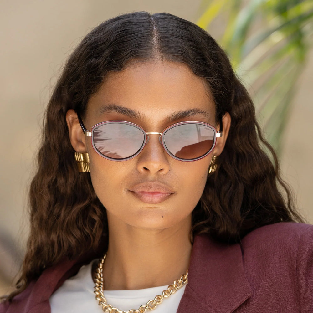 A woman wearing the FREYRS Jordan Women's Oval Sunglasses