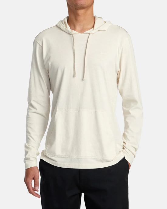 Front view of man wearing a long sleeve pullover hoodie in the color Latte 