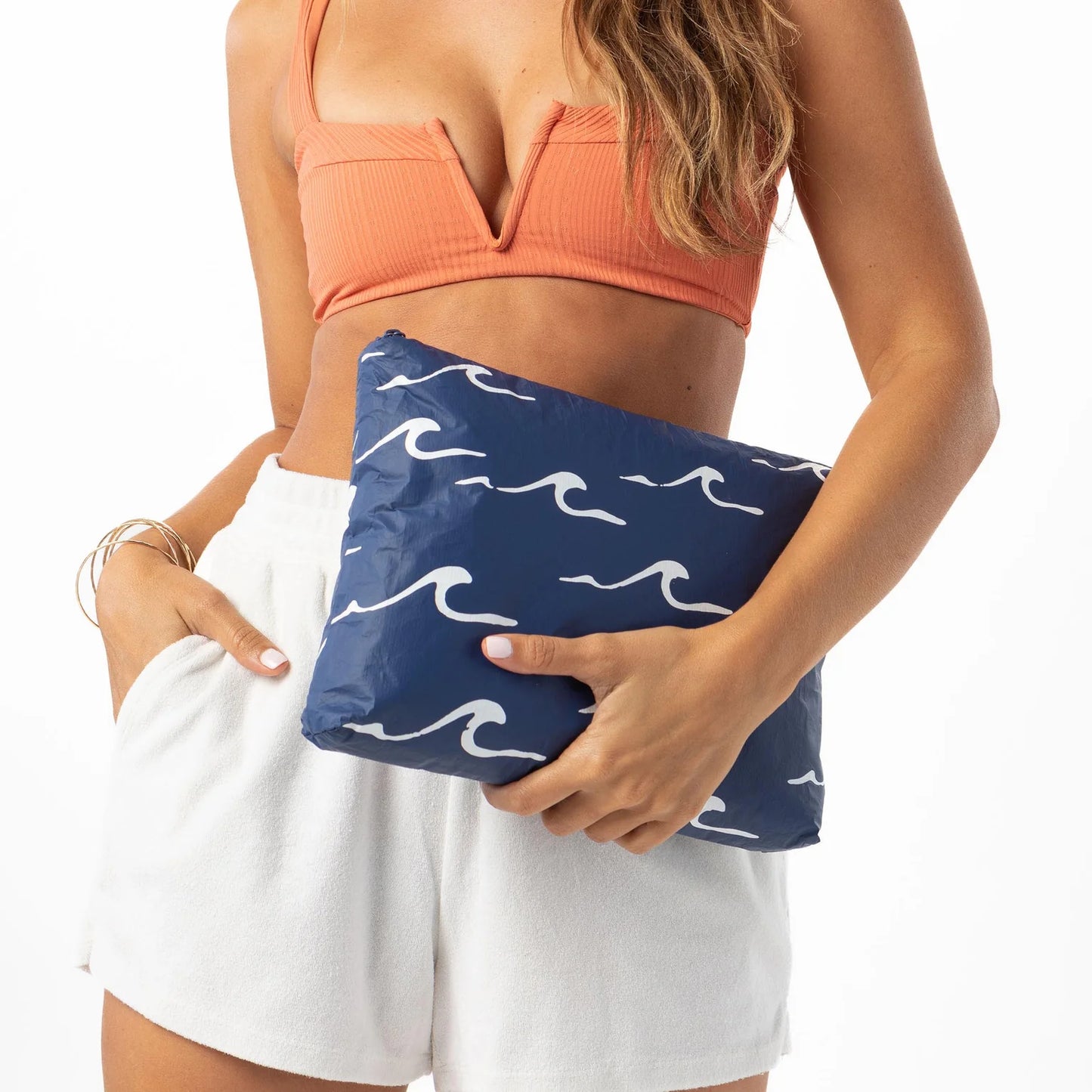 Woman holding the Mid Seaside Pouch by Aloha Collection