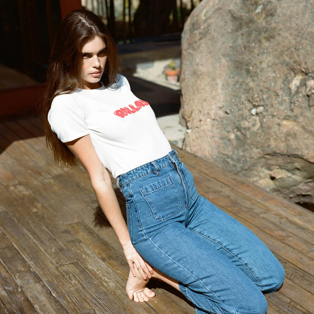 
                      
                        Woman sitting down wearing Rolla's Ashley Blue Sailor Jeans
                      
                    