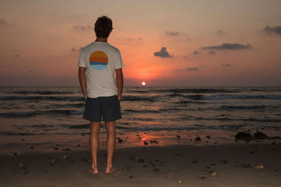 
                      
                        Back view of man wearing Mollusk's Realize Tee at the beach
                      
                    