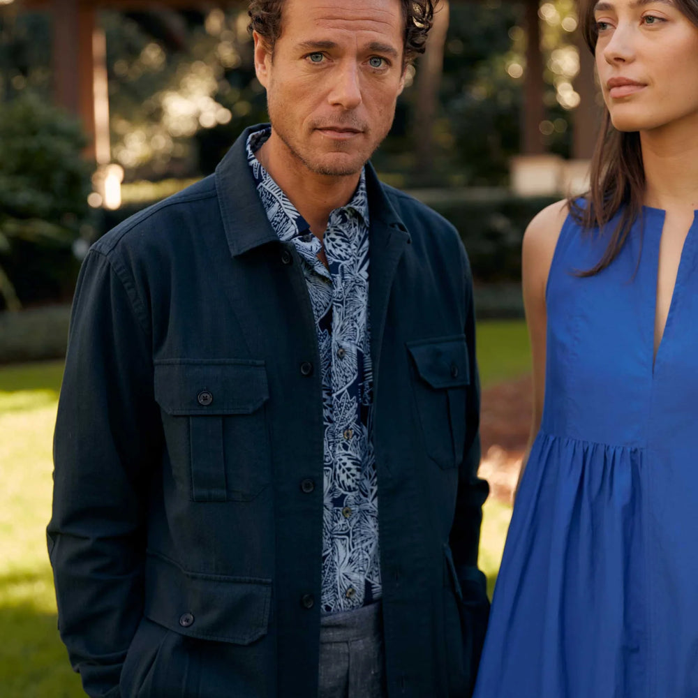 
                      
                        Man wearing Billy Reid's Short Sleeve Indigo Botanical Treme Block Shirt under a jacket
                      
                    