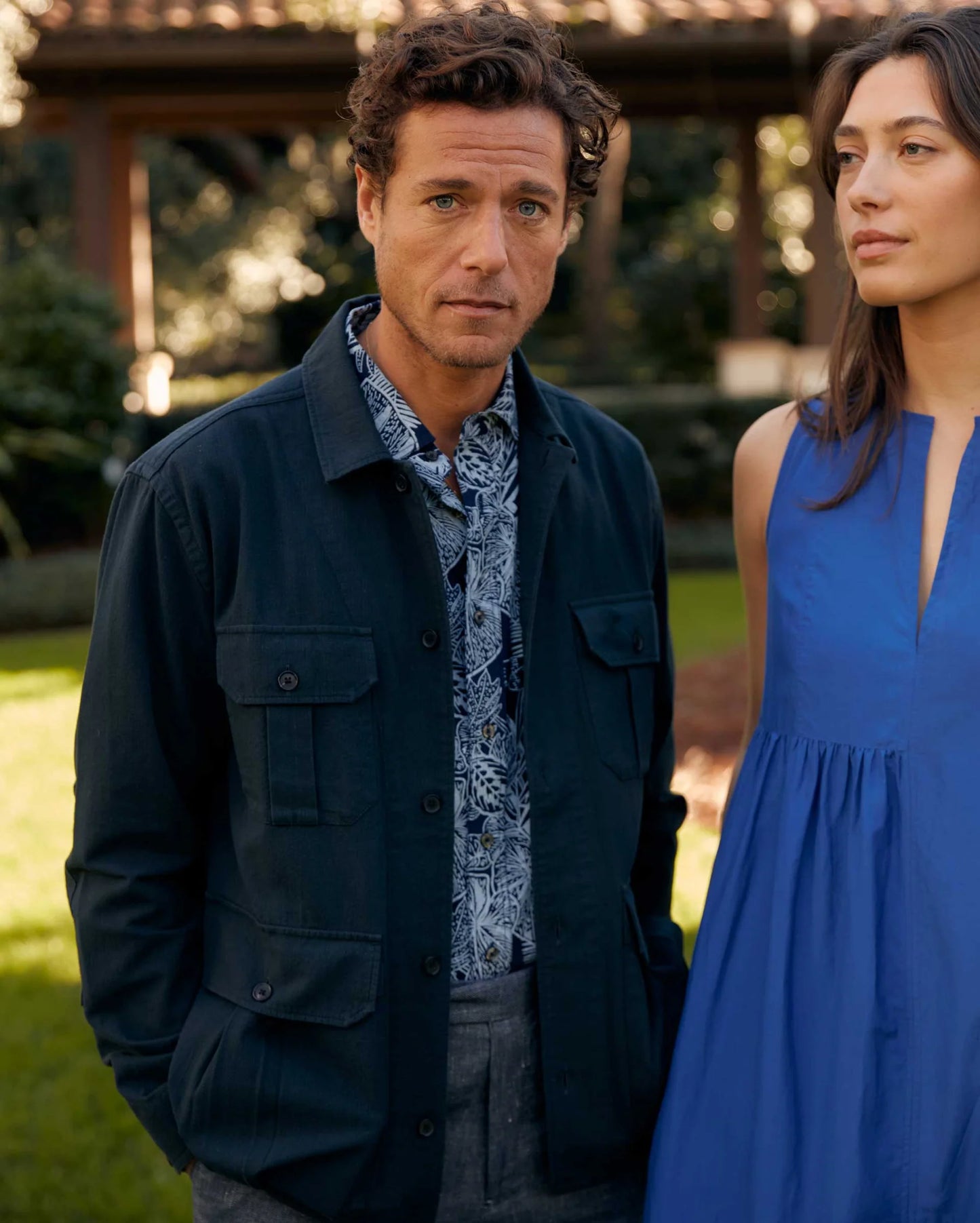 Man wearing Billy Reid's Short Sleeve Indigo Botanical Treme Block Shirt under a jacket
