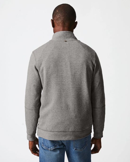 Back view of man wearing a grey quilted half zip pullover sweater by Billy Reid