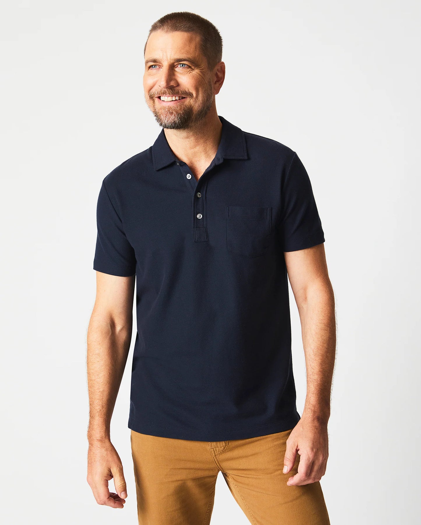 Front view of man wearing a dark blue short sleeve polo shirt by Billy Reid