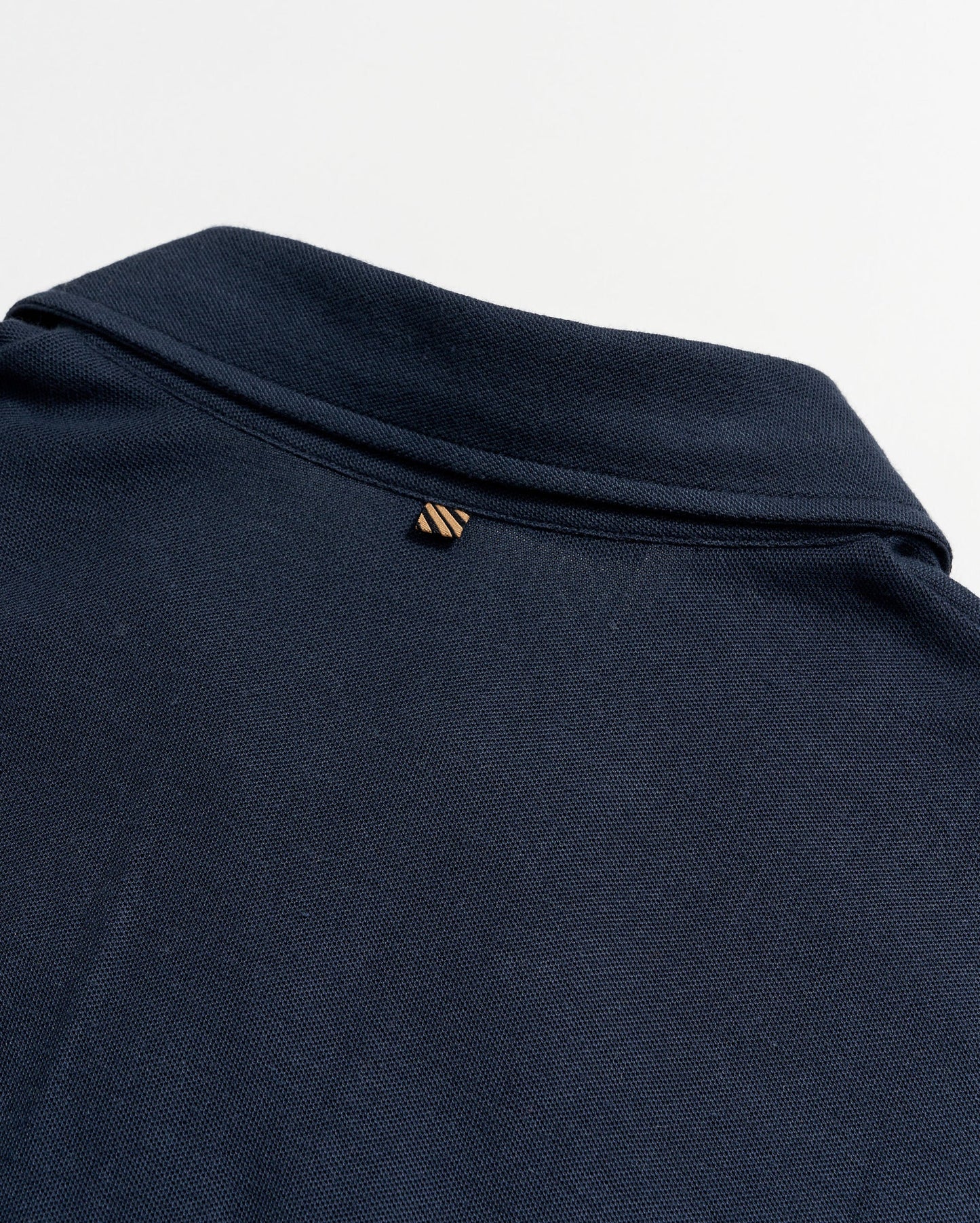 Back flat lay view of  a dark blue short sleeve polo shirt by Billy Reid