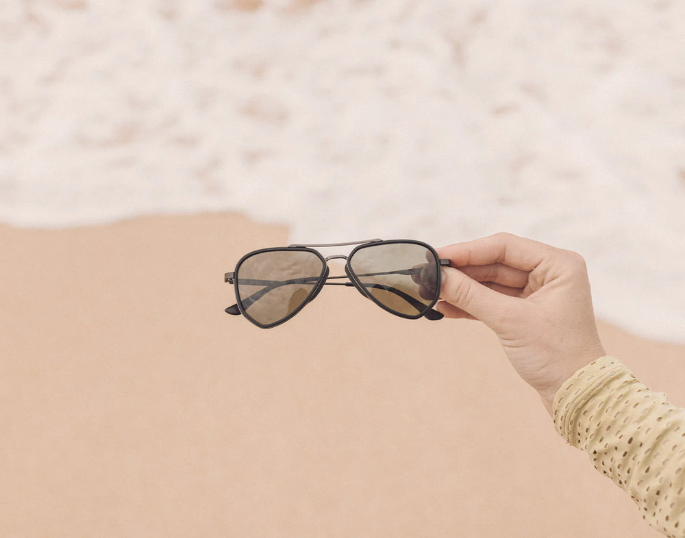 Beach shot of the Black Forest Astra Sunglasses by Sunski