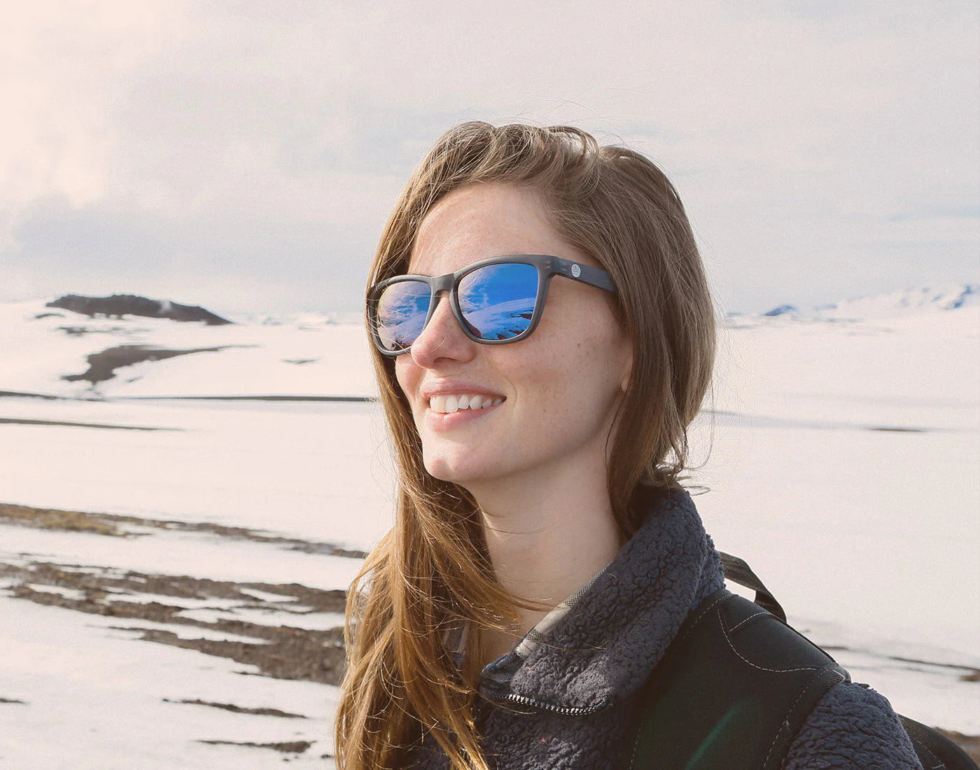 Woman wearing the Grey Blue Headland Sunglasses by Sunski