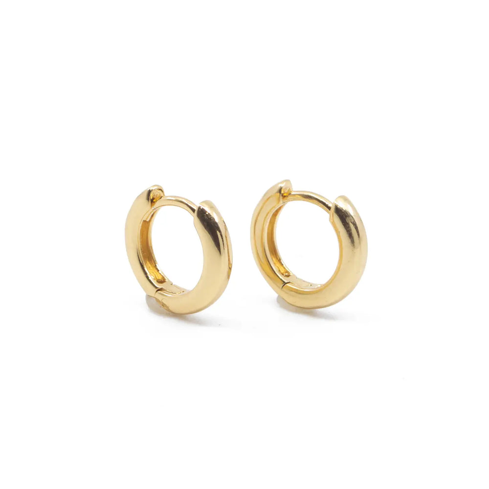 
                      
                        The Classic Gold Huggie Hoop Earrings by The Land Of Salt
                      
                    