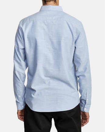 Back view of man wearing an long sleeve oxford blue men's button up shirt