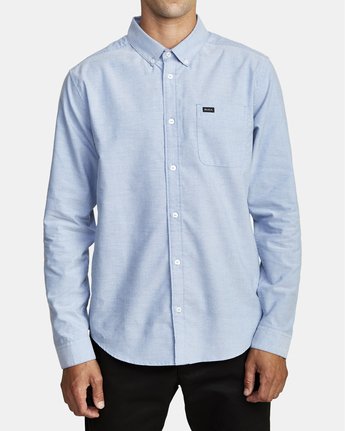 Front view of man wearing an long sleeve oxford blue men's button up shirt
